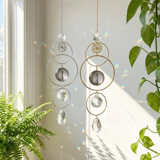 Decorative hanging crystal mobile with floral and circular designs in a bright room with plants.