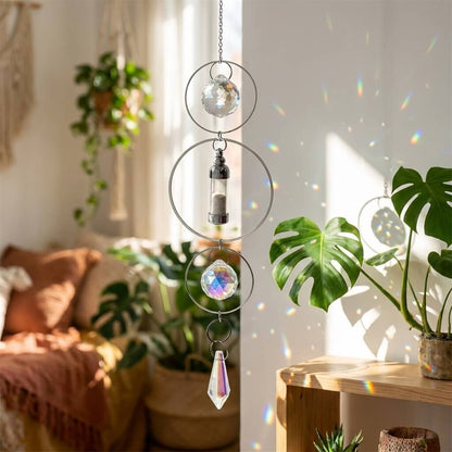Decorative hanging crystal chime in a sunlit room with plants and a sofa.