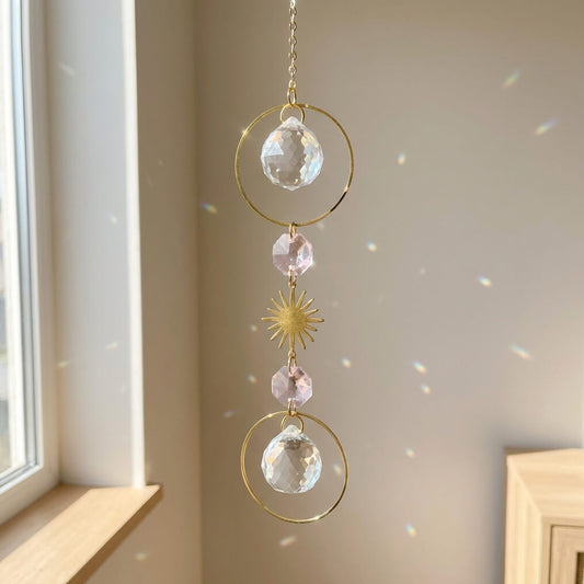 Decorative hanging crystal with gold accents in a room with a window.