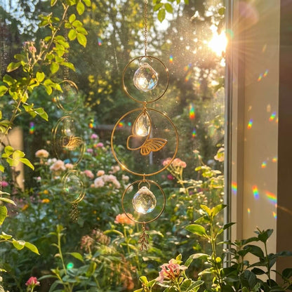 A gold butterfly suncatcher with delicate hanging crystals that scatter vibrant rainbow light across the room as sunlight passes through