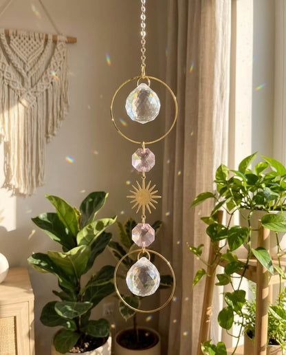 Decorative hanging crystal with plants and macrame wall art in the background