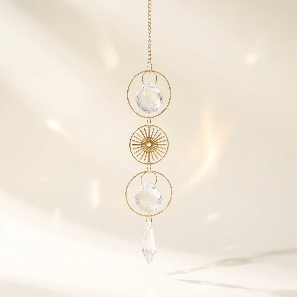 Decorative hanging crystal with gold frame on a neutral background