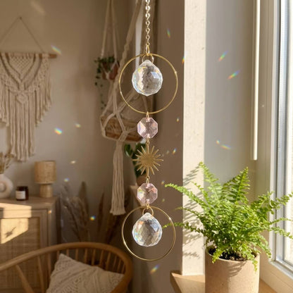 Decorative crystal hanging ornament in a home setting with plants and macrame wall art.