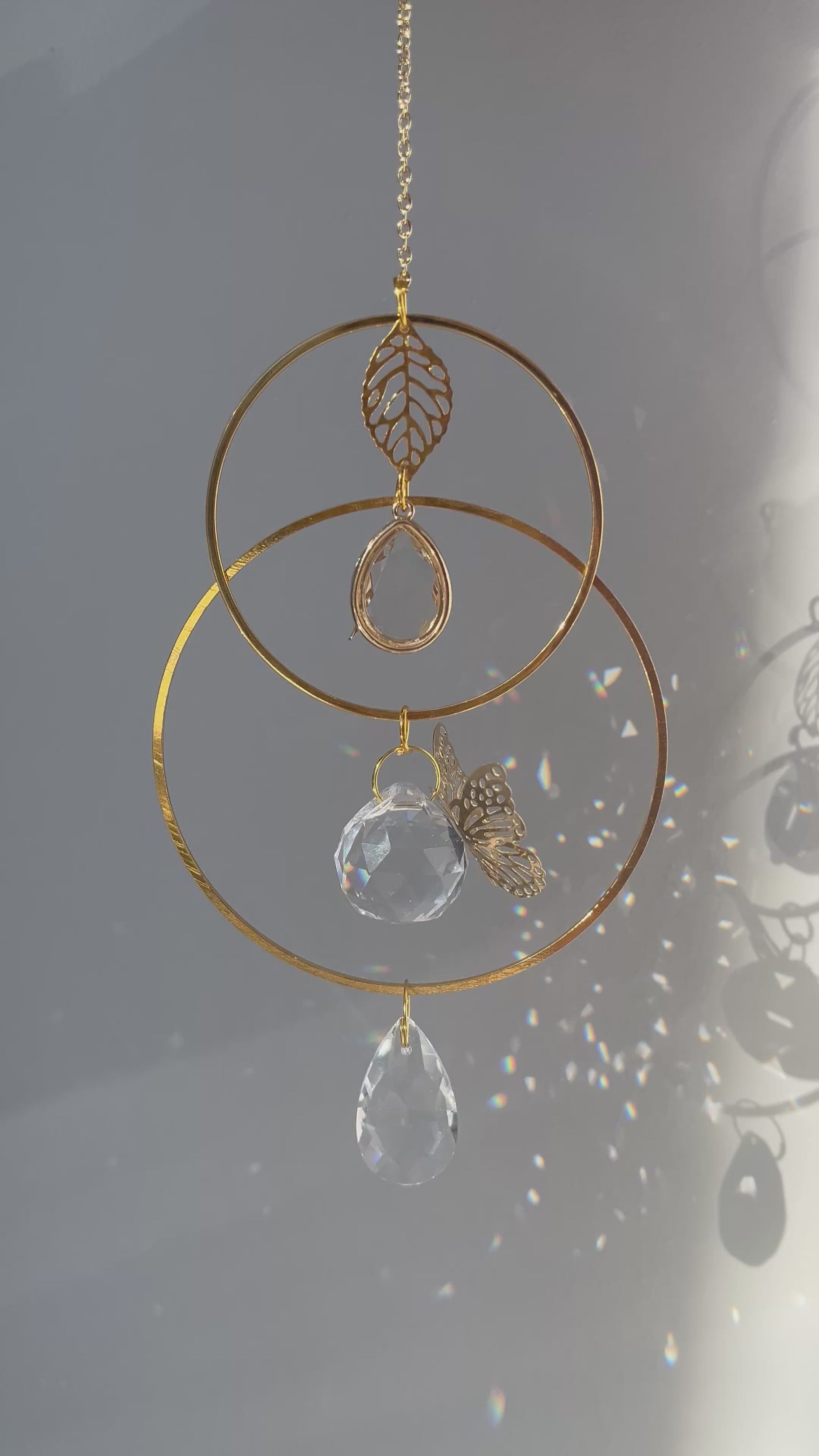 Memorial suncatcher urn with a small ash holder and a gentle butterfly symbolizing the soul’s journey, glowing in the light.