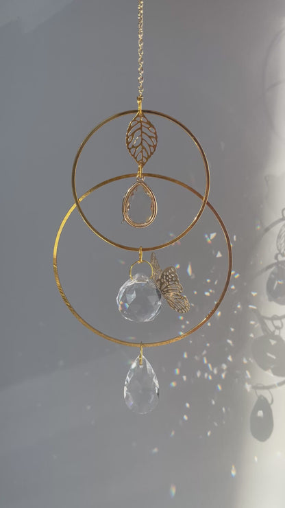 Memorial suncatcher urn with a small ash holder and a gentle butterfly symbolizing the soul’s journey, glowing in the light.