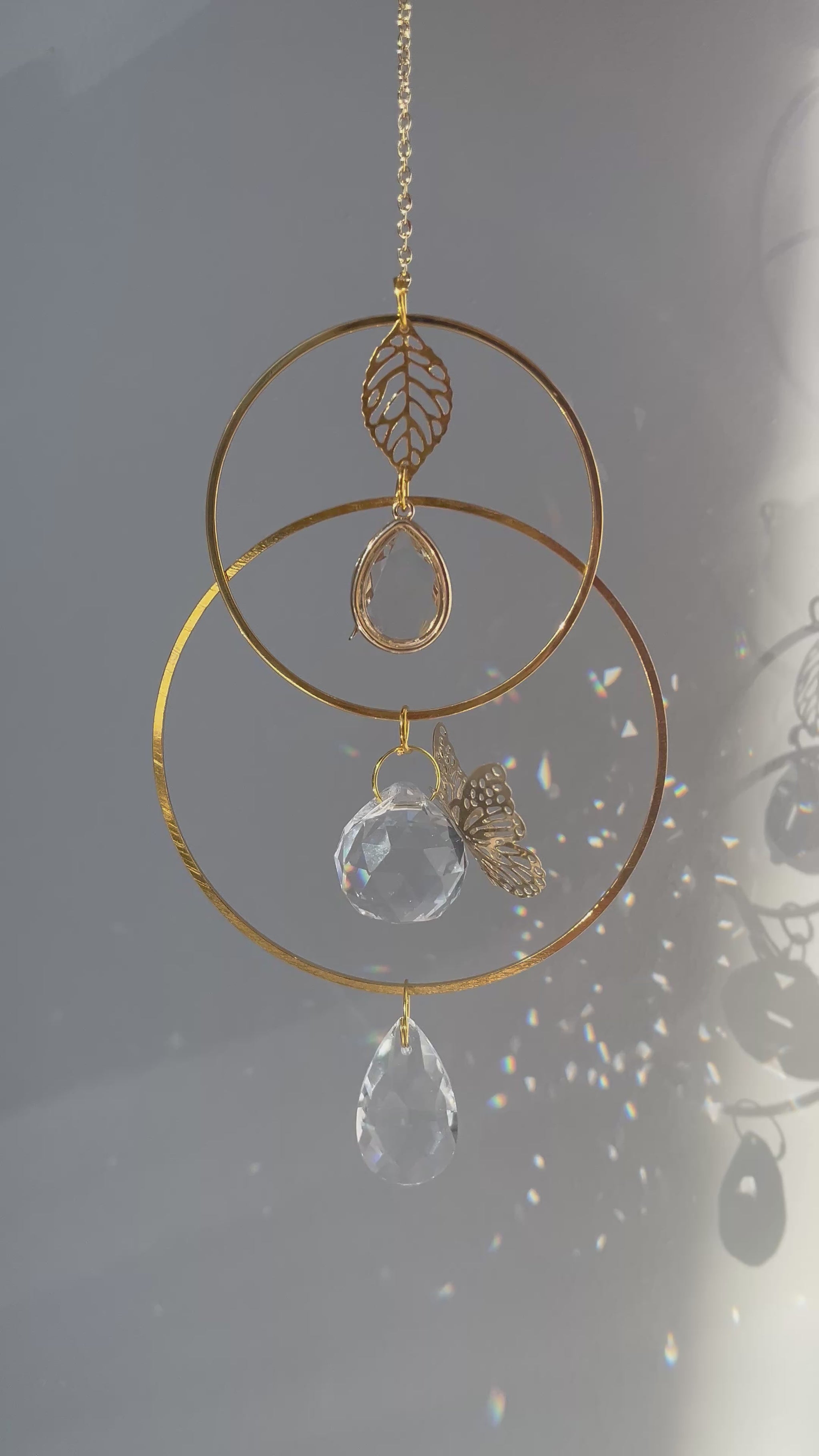Memorial suncatcher urn with a small ash holder and a gentle butterfly symbolizing the soul’s journey, glowing in the light.