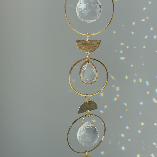 Memorial keepsake suncatcher casting colorful light on a wall, symbolizing peaceful remembrance.