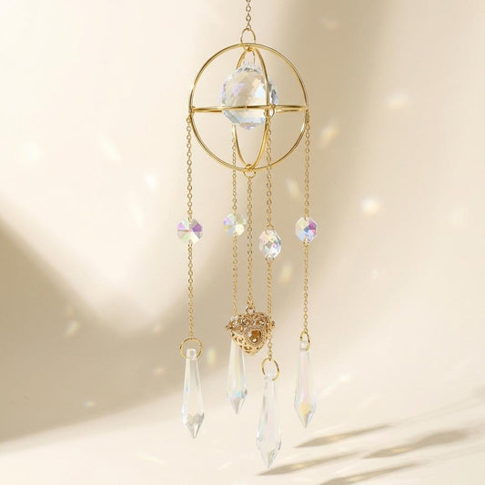Decorative hanging crystal mobile with gold frame on a soft beige background