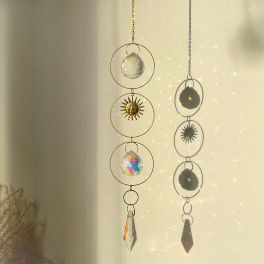 Decorative hanging with celestial-themed charms on a neutral background